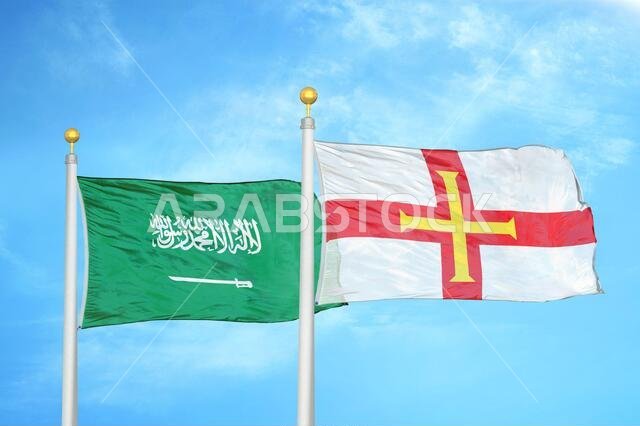 المملكة العربية السعودية وجيرنزي، علمان على سارية علم وسماء زرقاء ملبدة بالغيوم