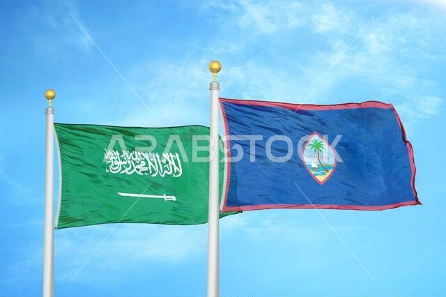 Saudi Arabia and Guam two flags on flagpoles and blue cloudy sky