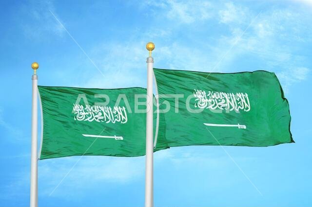 Saudi Arabia flags two flags on flagpoles and blue cloudy sky