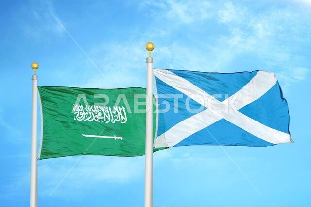 Saudi Arabia and Scotland two flags on flagpoles and blue cloudy sky