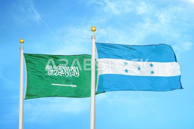 Saudi Arabia and Honduras two flags on flagpoles and blue cloudy sky