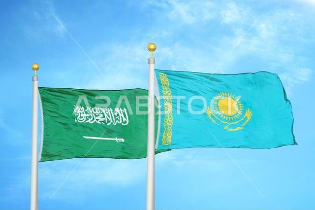 Saudi Arabia and Kazakhstan two flags on flagpoles and blue cloudy sky
