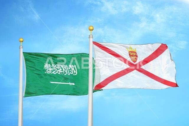 Saudi Arabia and Jersey two flags on flagpoles and blue cloudy sky