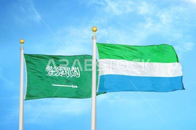 Saudi Arabia and Sierra Leone two flags on flagpoles and blue cloudy sky