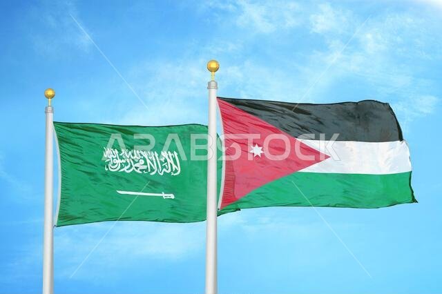 Saudi Arabia and Jordan two flags on flagpoles and blue cloudy sky