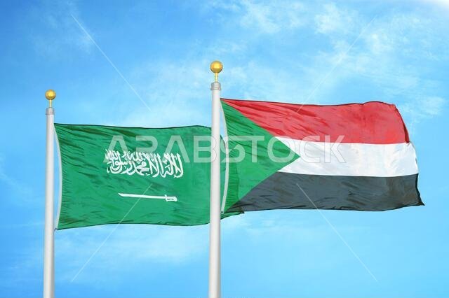 السعودية والسودان، علمان على ساريتين وسماء زرقاء ملبدة بالغيوم