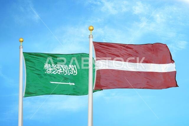 المملكة العربية السعودية ولاتفيا، علمان على سارية علم، وسماء زرقاء ملبدة بالغيوم