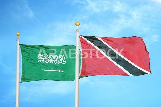 Saudi Arabia and Trinidad and Tobago two flags on flagpoles and blue cloudy sky