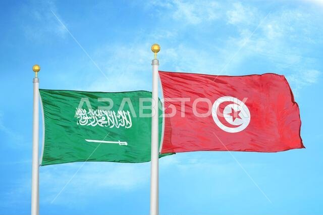 السعودية وتونس، علمان على سارية علم، وسماء زرقاء ملبدة بالغيوم