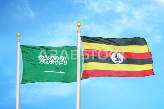 Saudi Arabia and Uganda two flags on flagpoles and blue cloudy sky