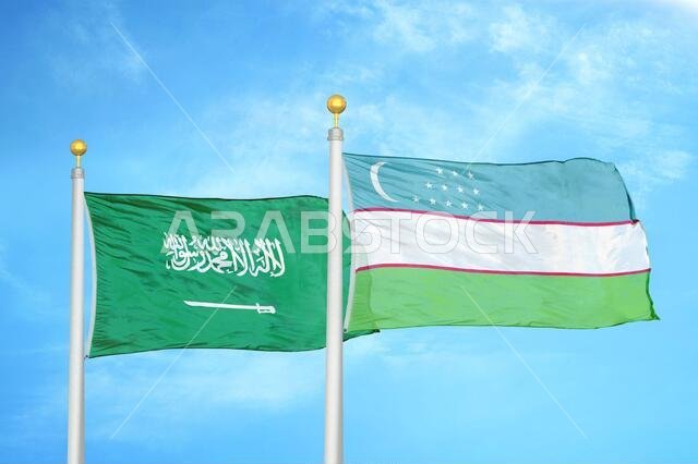 Saudi Arabia and Uzbekistan two flags on flagpoles and blue cloudy sky