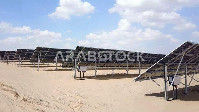 close up of solar power panels in desert with view of distribution board with cloudy sky in background. photovoltaic PV modules in a Solar energy plan