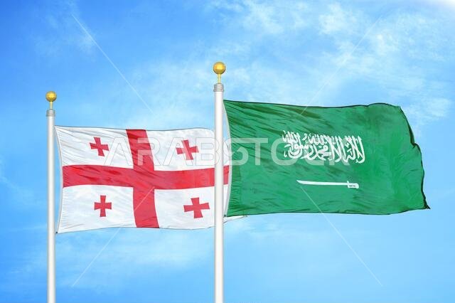 Georgia and Saudi Arabia two flags on flagpoles and blue sky
