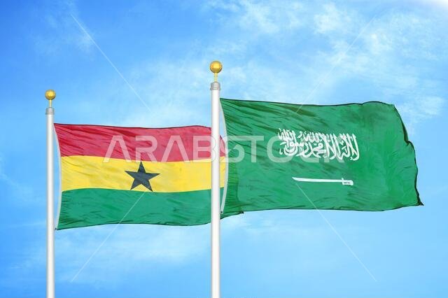 Ghana and Saudi Arabia two flags on flagpoles and blue sky