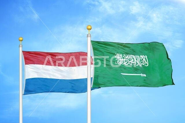 Netherlands and Saudi Arabia two flags on flagpoles and blue sky