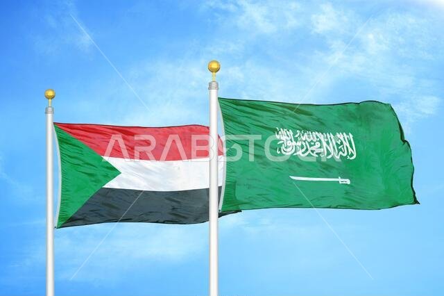 Sudan and Saudi Arabia two flags on flagpoles and blue sky