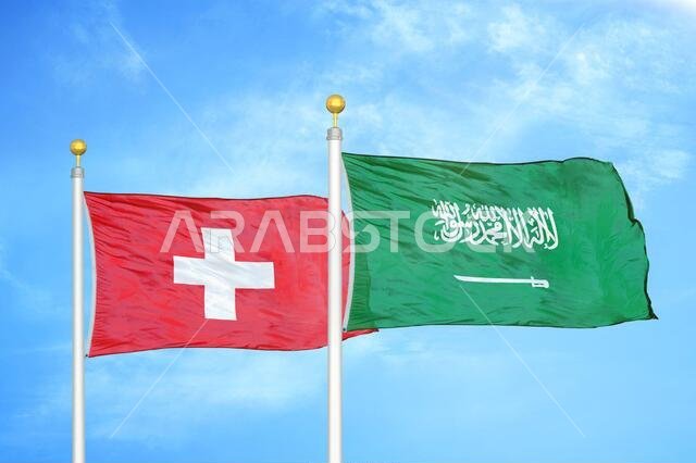 Switzerland and Saudi Arabia two flags on flagpoles and blue sky