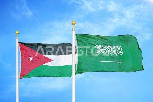 الأردن والسعودية، علمان على سارية علم وسماء زرقاء ملبدة بالغيوم