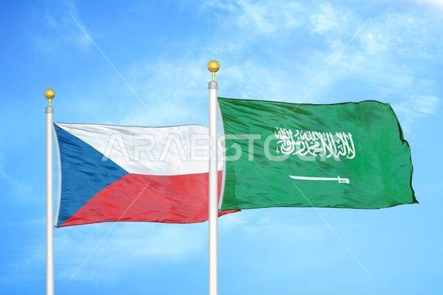 Czech and Saudi Arabia two flags on flagpoles and blue cloudy sky