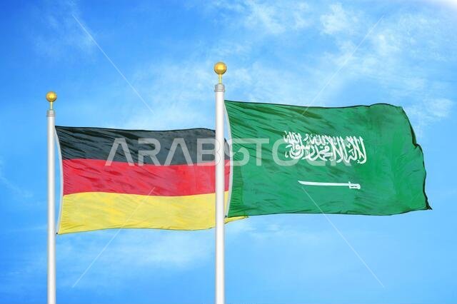 ألمانيا والمملكة العربية السعودية، علمان على سارية علم وسماء زرقاء ملبدة بالغيوم