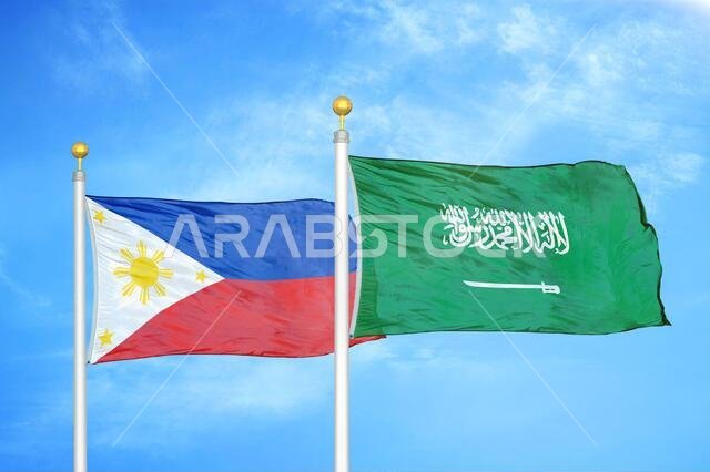 Philippines and Saudi Arabia two flags on flagpoles and blue cloudy sky