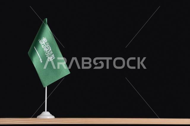 National table flag of Saudi Arabia on black background. Green flag with sword.