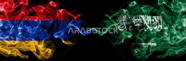 Armenia vs Saudi Arabia, Arabian smoky mystic flags placed side by side. Thick colored silky abstract smoke flags