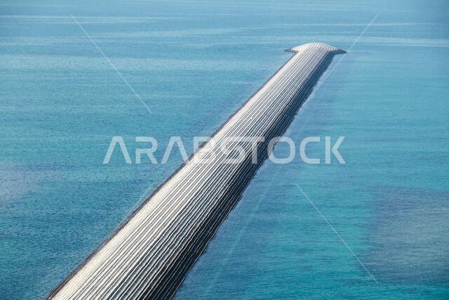 Breakwater made of concrete blocks. Modern wave protection construction for harbor safety