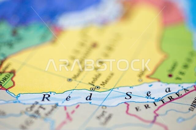 Shallow depth of field focus on geographical map location of Red Sea off coast of Saudi Arabia on atlas