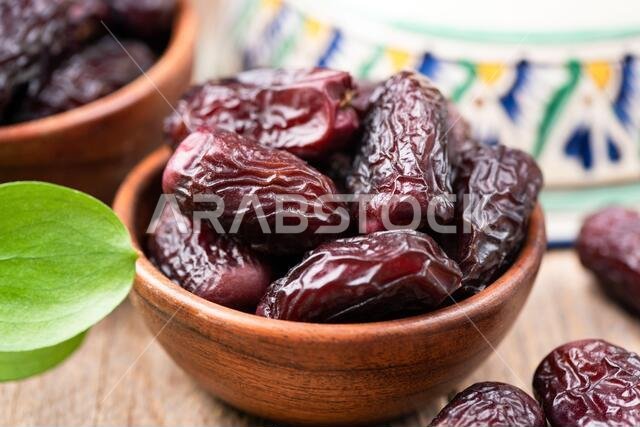 Dried dates in bowl. Tasty medjool dates. Arabic islamic food