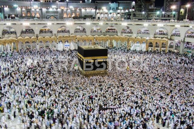 Holy Kaaba. Crowd of muslims walking around Kaaba for Tawaf during Hajj.