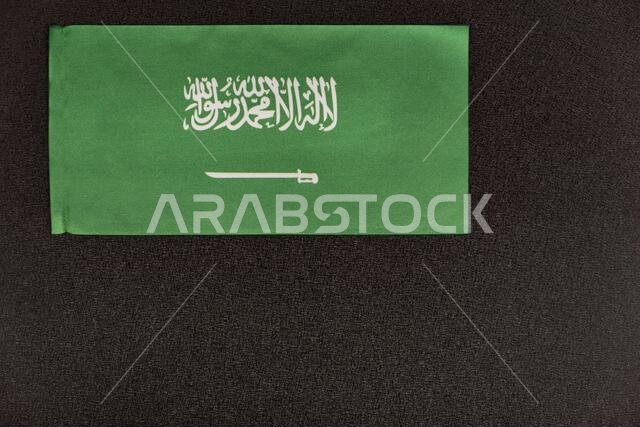 Flag of Saudi Arabia on black background. Kingdom of Saudi Arabia. Green flag with sword.