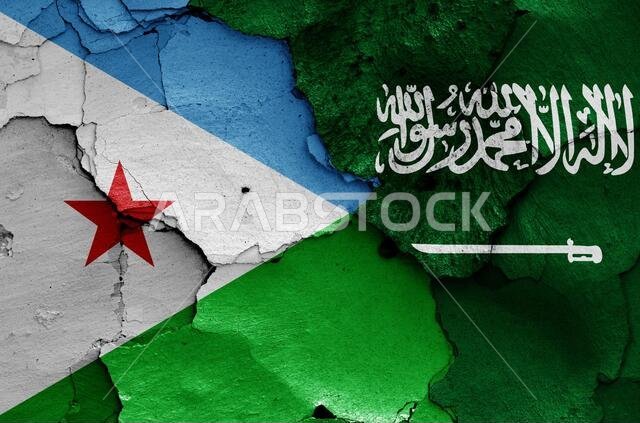 flags of Djibouti and Saudi Arabia painted on cracked wall