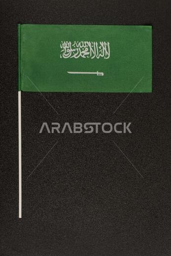 desktop flag of Kingdom of Saudi Arabia on black background. Green flag with sword. Vertical frame.