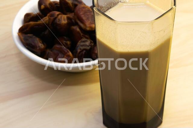 Hushaf - date milk, traditional Ramadan dish, cooking, ingredients, glass with date milk - khushaf and dish with dates are on the table