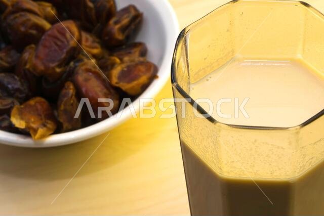 Hushaf - date milk, traditional Ramadan dish, cooking, ingredients, glass with date milk - khushaf and dish with dates are on the table