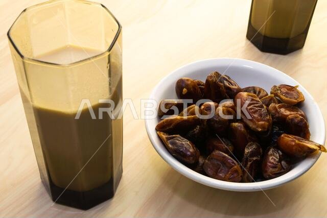 Hushaf - date milk, traditional Ramadan dish, cooking, ingredients, two glasses with date milk - Hushaf and the dish with dates are on the table