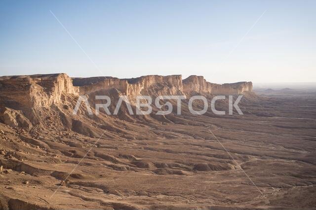From above picturesque scenery of majestic range of cliffs in desert location in the Edge of the World in Saudi Arabia