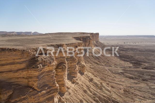 From above picturesque scenery of majestic range of cliffs in desert location in the Edge of the World in Saudi Arabia