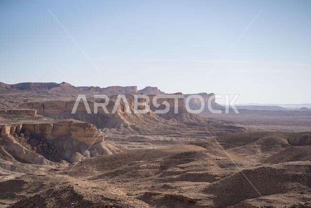 From above picturesque scenery of majestic range of cliffs in desert location in the Edge of the World in Saudi Arabia