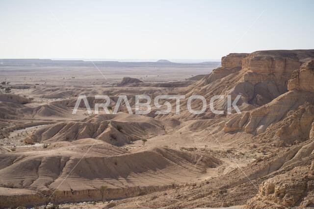 From above picturesque scenery of majestic range of cliffs in desert location in the Edge of the World in Saudi Arabia