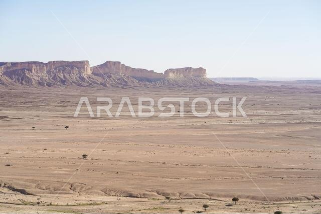 From above picturesque scenery of majestic range of cliffs in desert location in the Edge of the World in Saudi Arabia