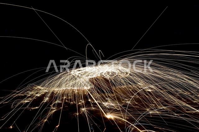 A steel wool on fire at night (night photography using a slow shutter speed) - selective focused on the subject.