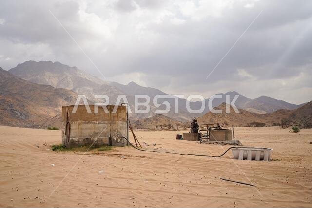 Subsoil water well in desert location near mountains in cloudy day in Saudi Arabia