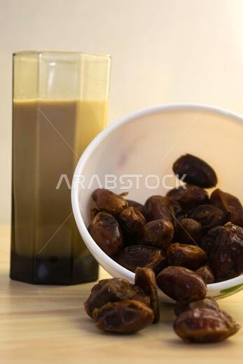 Hushaf - date milk, traditional Ramadan dish, cooking, ingredients, glass with date milk - khushaf and dish with dates are on the table
