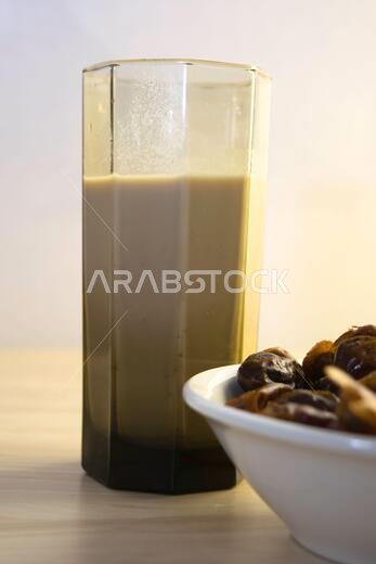 Hushaf - date milk, traditional Ramadan dish, cooking, ingredients, glass with date milk - khushaf and dish with dates are on the table