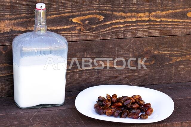 Hushaf - date milk, a traditional dish to Ramadan, cooking, ingredients, dates in the plate and milk in bottles are on the table