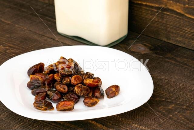 Hushaf - date milk, a traditional dish to Ramadan, cooking, ingredients, dates in the plate and milk in bottles are on the table