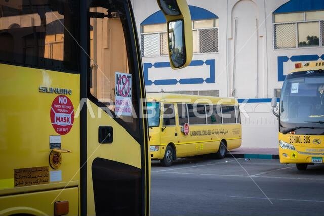 Yellow school bus in Abu Dhabi, United Arab Emirates, Dubai, Emirates, Gulf, Middle east. Awareness signs and symbol was written in arabic language at Yellow school bus in Abu Dhabi, United Arab Emirates, Dubai, Emirates, Gulf, Middle east. Awareness signs and symbol was written in arabic language at