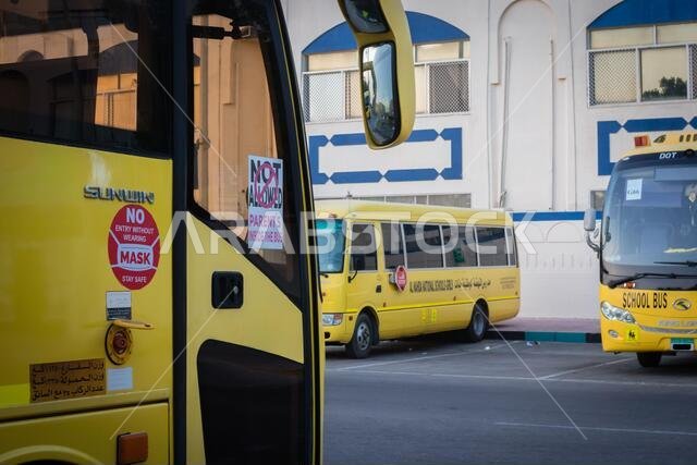 Yellow school bus in Abu Dhabi, United Arab Emirates, Dubai, Emirates, Gulf, Middle east. Awareness signs and symbol was written in arabic language at Yellow school bus in Abu Dhabi, United Arab Emirates, Dubai, Emirates, Gulf, Middle east. Awareness signs and symbol was written in arabic language at